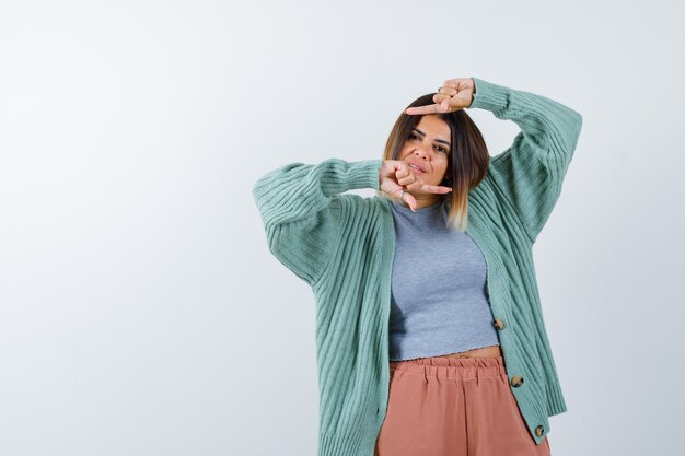 Woman pointing left and right in casual clothes and looking jolly. front view.