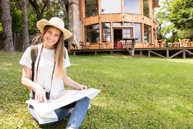 Woman pointing at the map and looking at camera