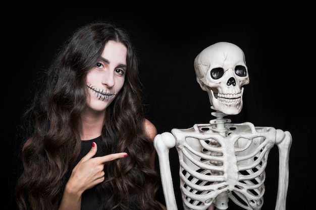 Woman pointing at skeleton