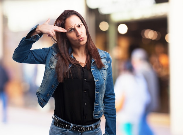 Woman pointing with a pistol made with her hand