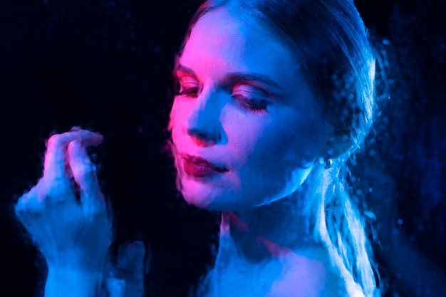 Free photo woman portrait with blue lights visual effects