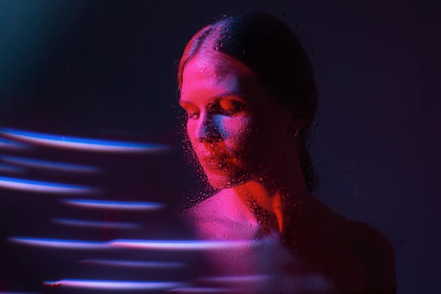 Free photo woman portrait with blue lights visual effects