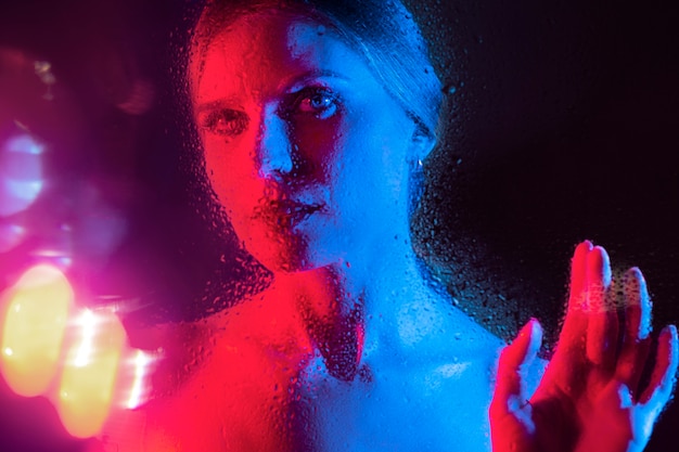 Free photo woman portrait with blue lights visual effects