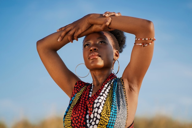 Free photo woman posing in an arid environment while wearing native african clothing