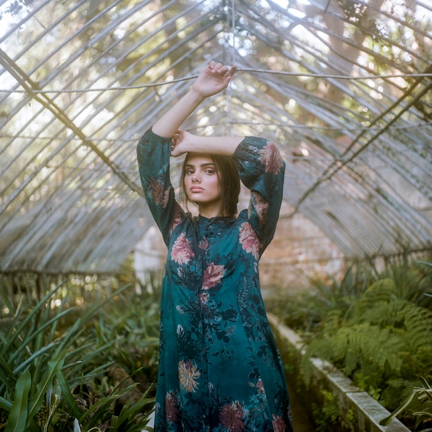 Free photo woman posing in a green house