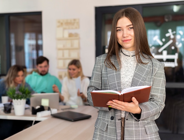 Woman posing next to her coworkers