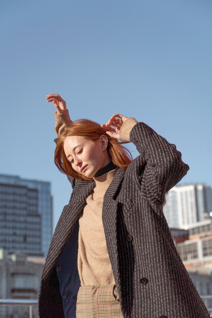 Woman posing outdoors against the sky