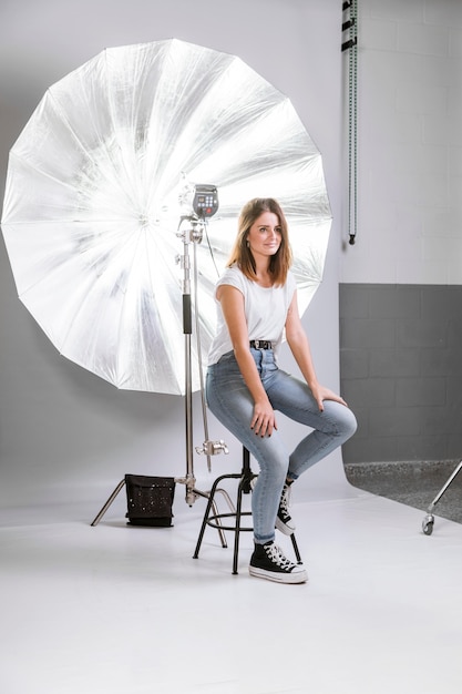 Free photo woman posing for a photo on chair