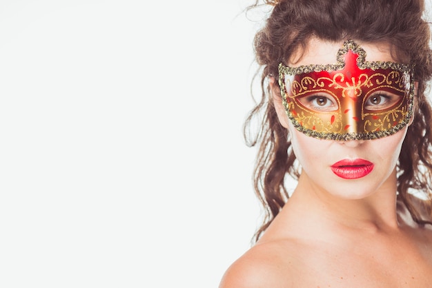 Free Photo woman posing in red and golden mask