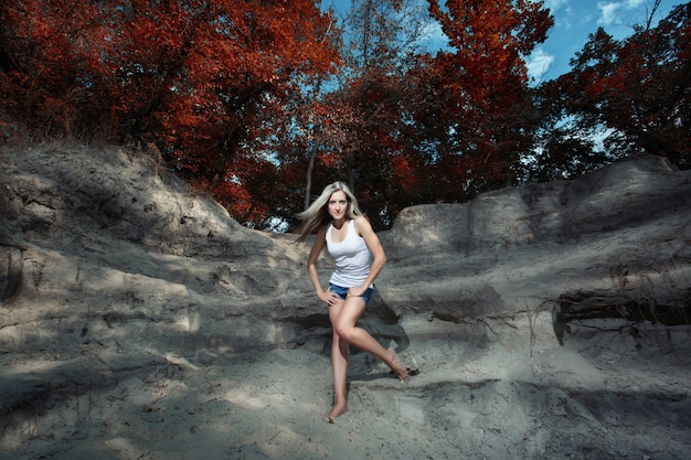 Free Photo woman posing on the rocks in a forest