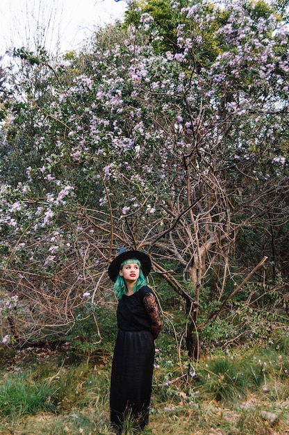 Free photo woman posing at tree in costume