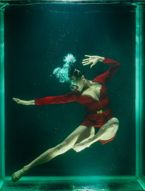 Woman posing under the water