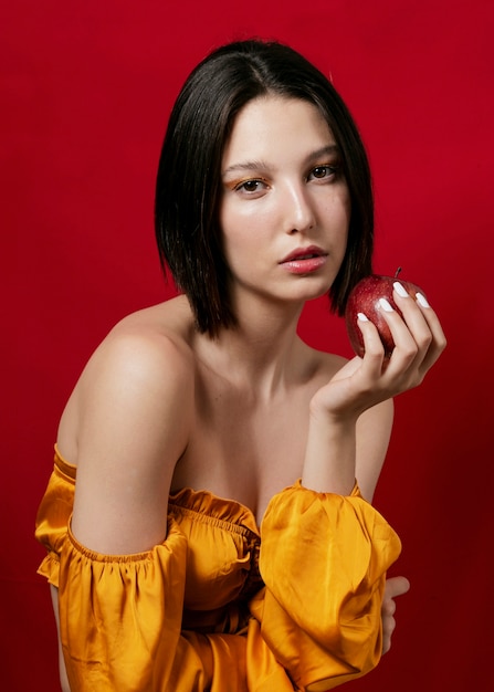 Woman posing with apple in hand