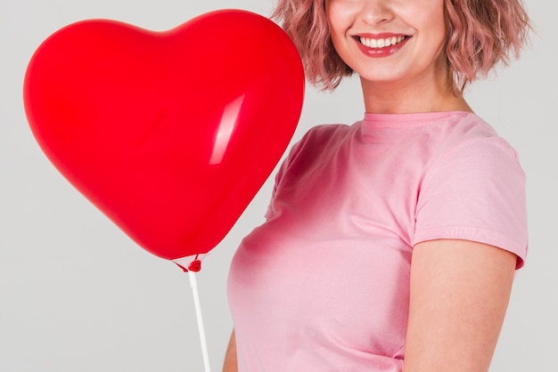 Free Photo woman posing with balloon for valentines