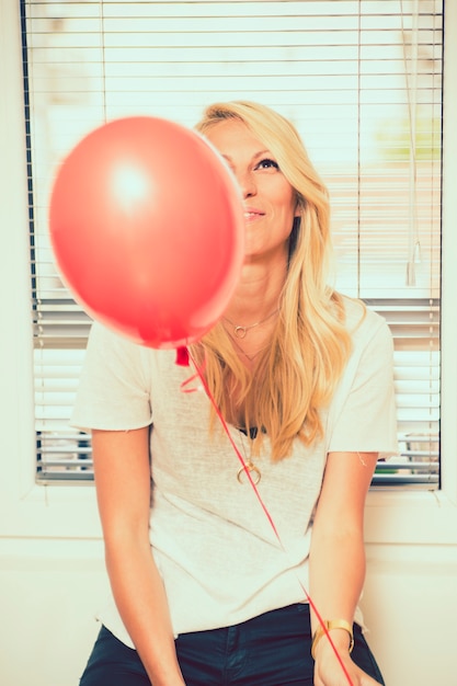 Woman posing with balloon