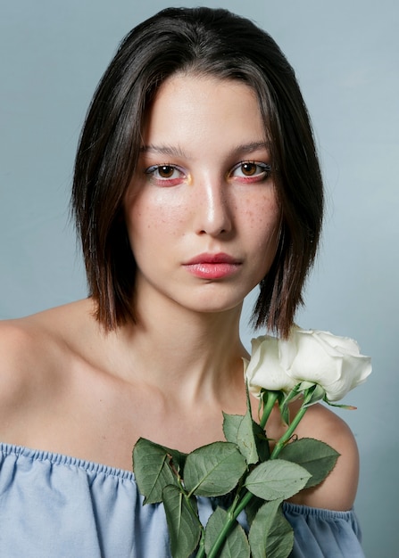 Free photo woman posing with bunch of roses