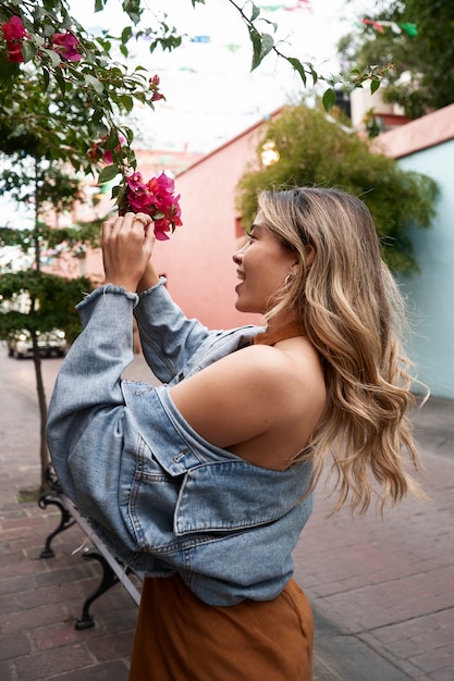 Woman posing with flowers side view