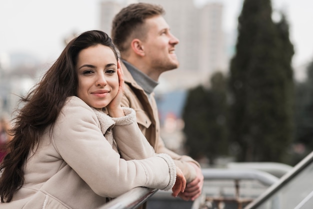 Woman posing with man outdoors