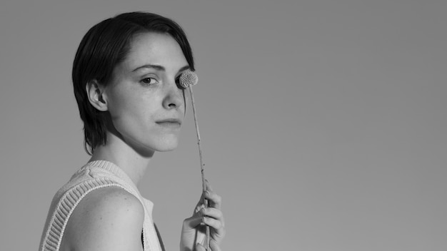 Woman posing with plant side view