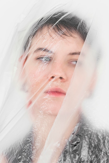 Free photo woman posing with plastic foil