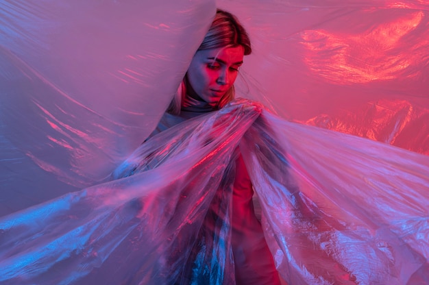 Free Photo woman posing with plastic foil