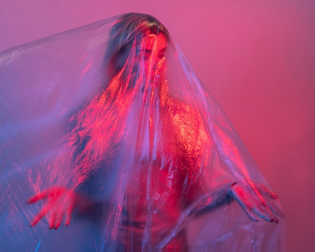 Free photo woman posing with plastic foil