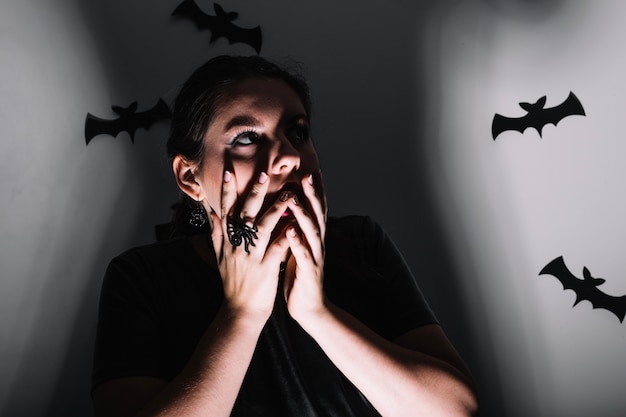 Free photo woman posing with scary bats