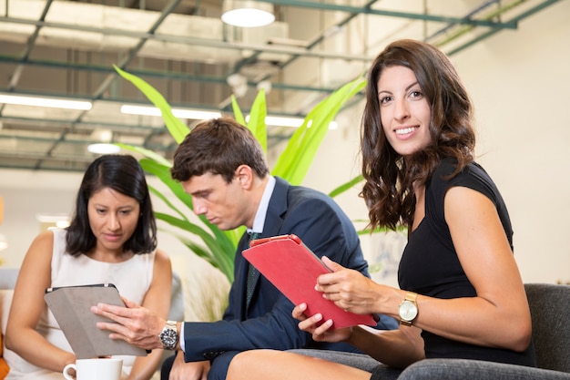 Woman posing with tablet at office