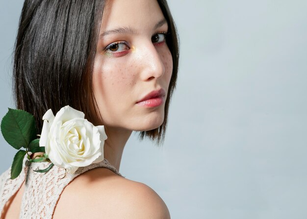 Woman posing with white rose