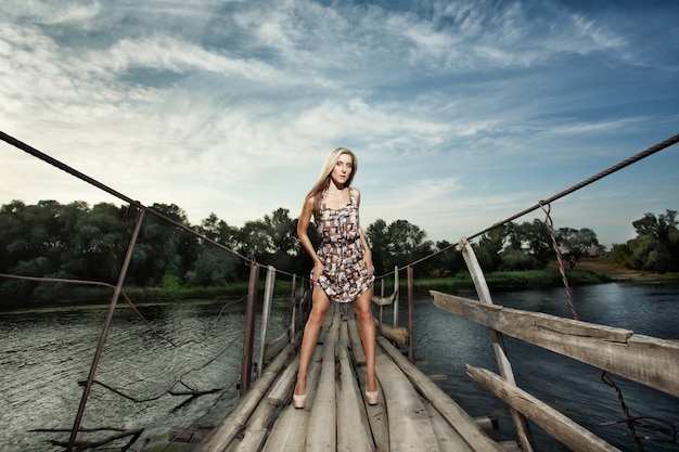 Woman posing on a wooden bridge