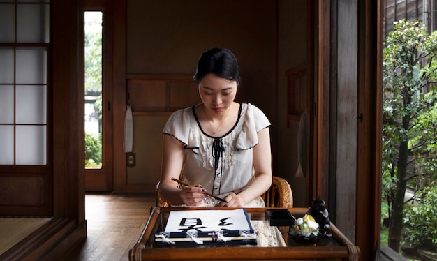 Free photo woman practicing japanese handwriting