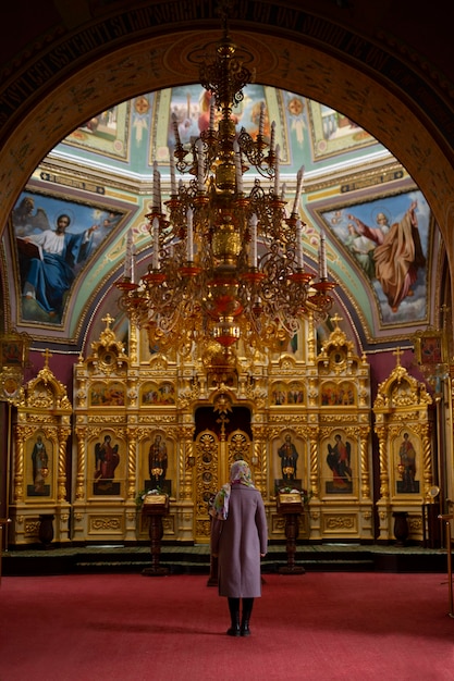 Free photo woman praying in church for religious pilgrimage