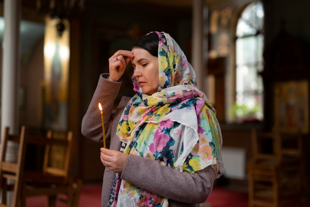 Free photo woman praying in church for religious pilgrimage