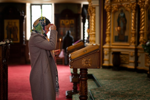 Free Photo woman praying in church for religious pilgrimage