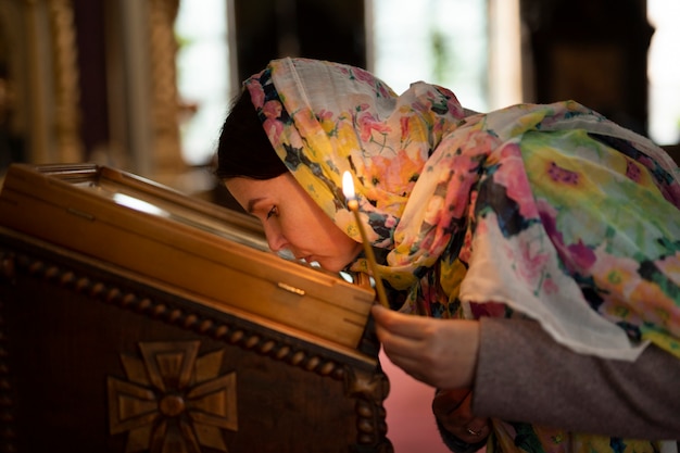 Woman praying in church for religious pilgrimage