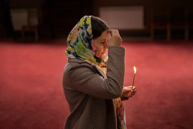 Free photo woman praying in church for religious pilgrimage