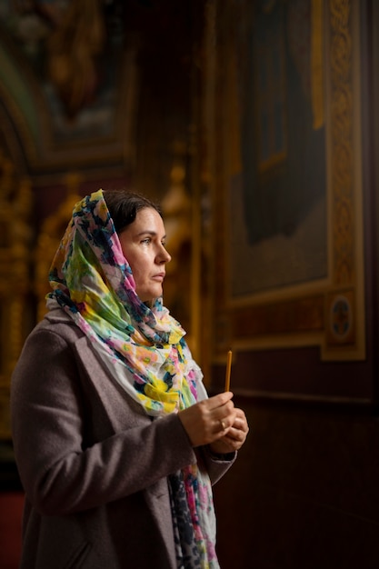 Free photo woman praying in church for religious pilgrimage