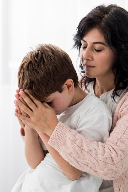 Woman praying with her child