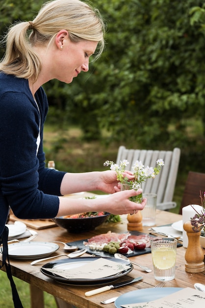 Free Photo woman preparing the dinner table