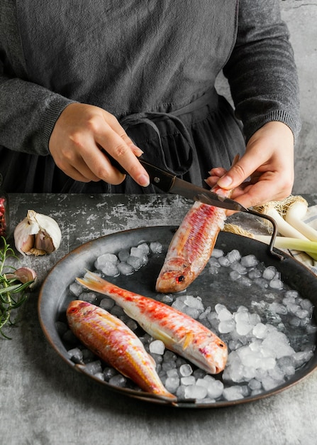 Woman preparing a fish for cooking