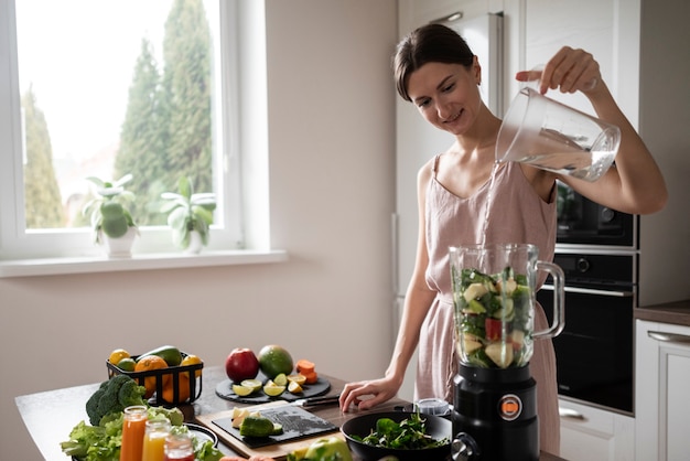 Free photo woman preparing her juice recipe