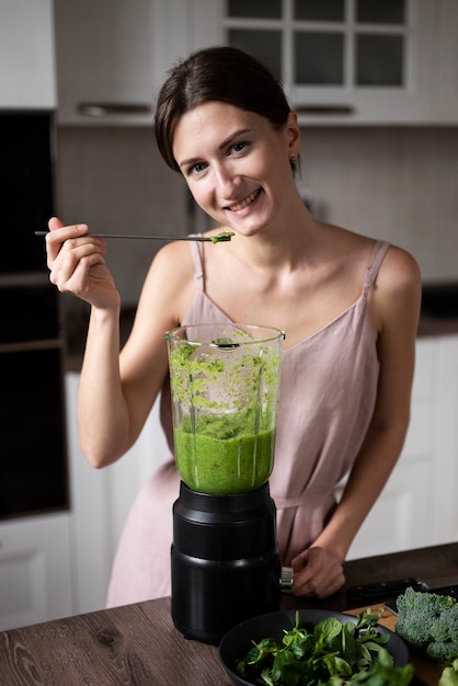 Free Photo woman preparing her juice recipe