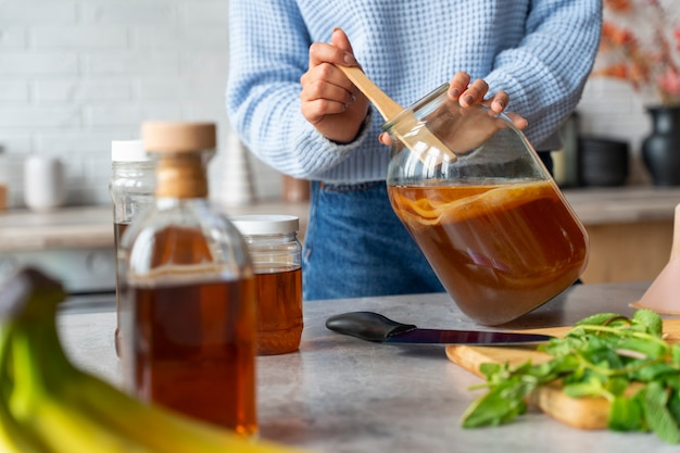 Woman preparing kombucha front view