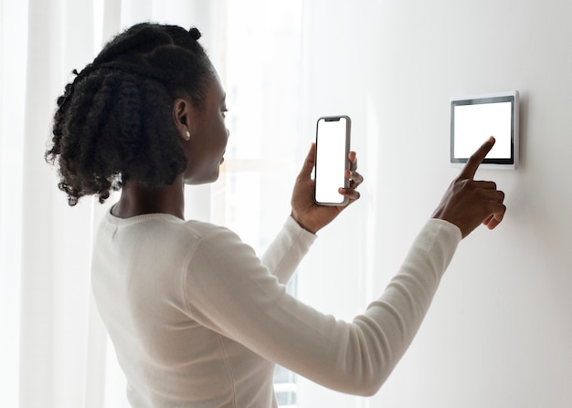 Woman pressing on smart home automation panel monitor