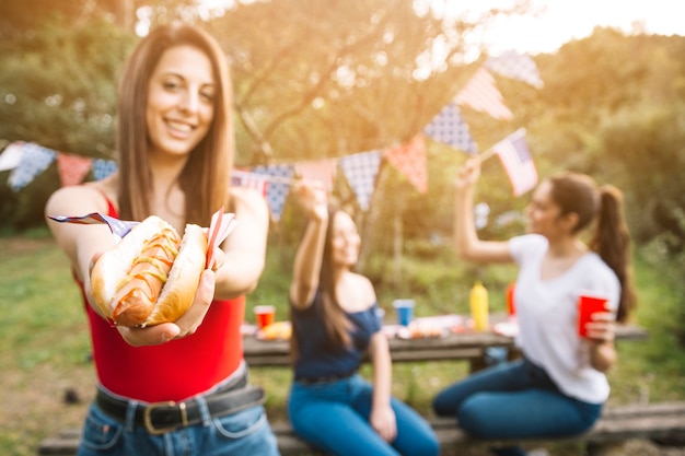 Free photo woman proposing hot-dog