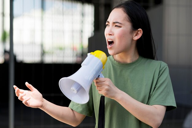 Woman protesting and talking on megaphone