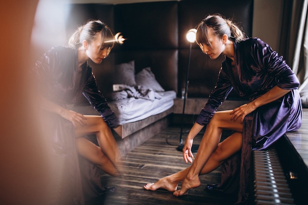 Free Photo woman in purple bathrobe in bedroom