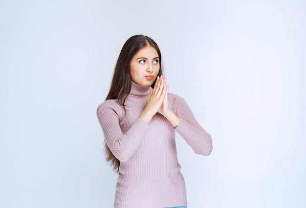 woman in purple shirt uniting hands and dreaming.