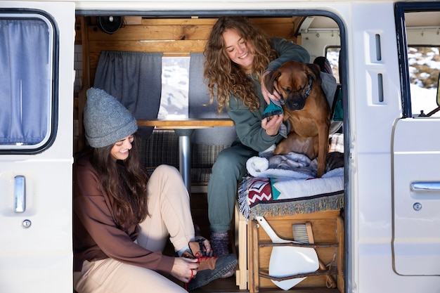 Free photo woman putting on her shoes to go on a winter adventure