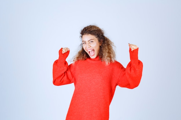 woman raising her fists and feeling successful. 